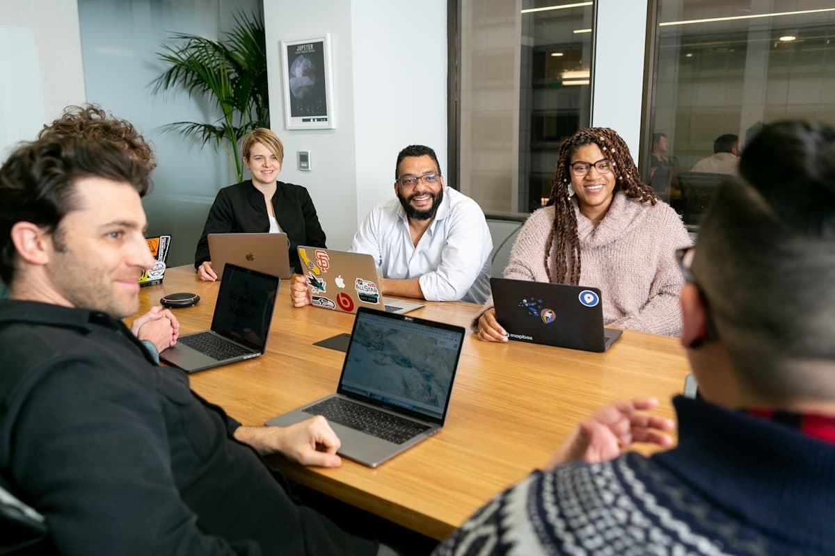 DBM consultants discussing a client's company formation around a meeting table